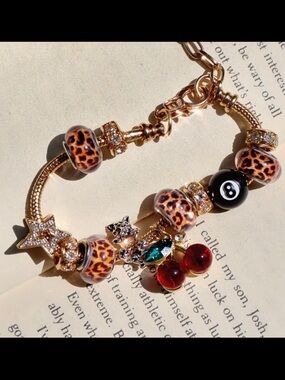 Gold-Tone Leopard Bead Charm Bracelet with Red Cherry and Eight Ball Charms